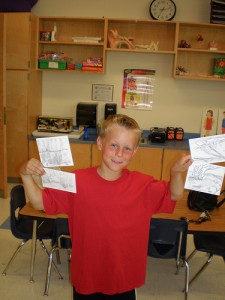 Cole holding postcards he designed