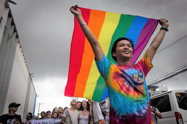 man-holding-rainbow-flag